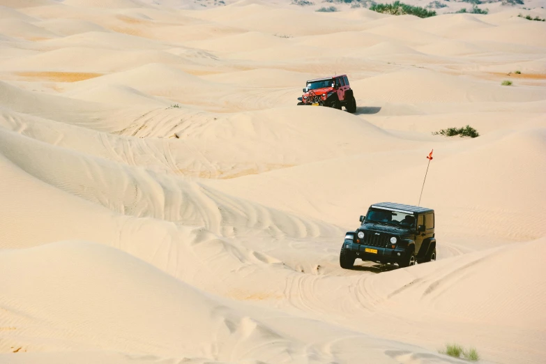 a couple of jeeps that are in the sand, pexels contest winner, square, black and yellow and red scheme, majestic dunes, sport