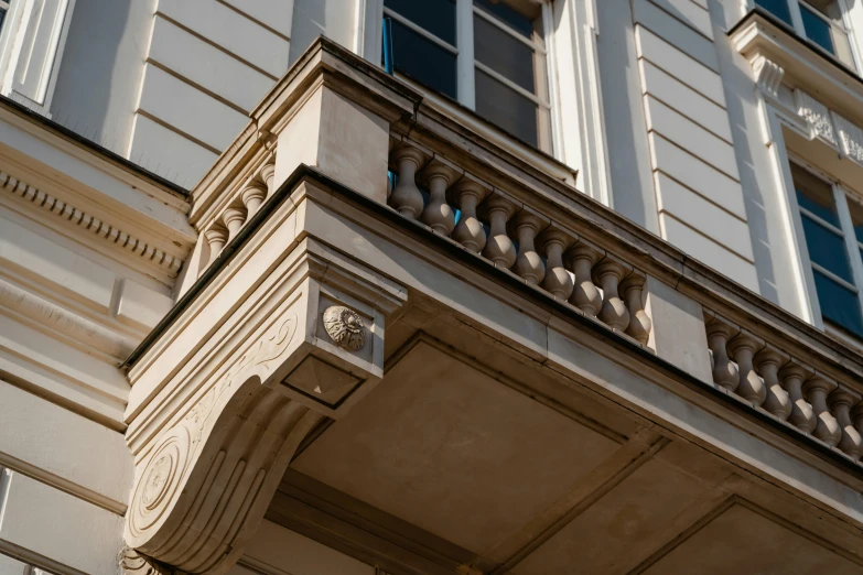 a clock that is on the side of a building, inspired by Albert Paris Gütersloh, unsplash, neoclassicism, concrete balcony, front profile, limestone, biedermeier