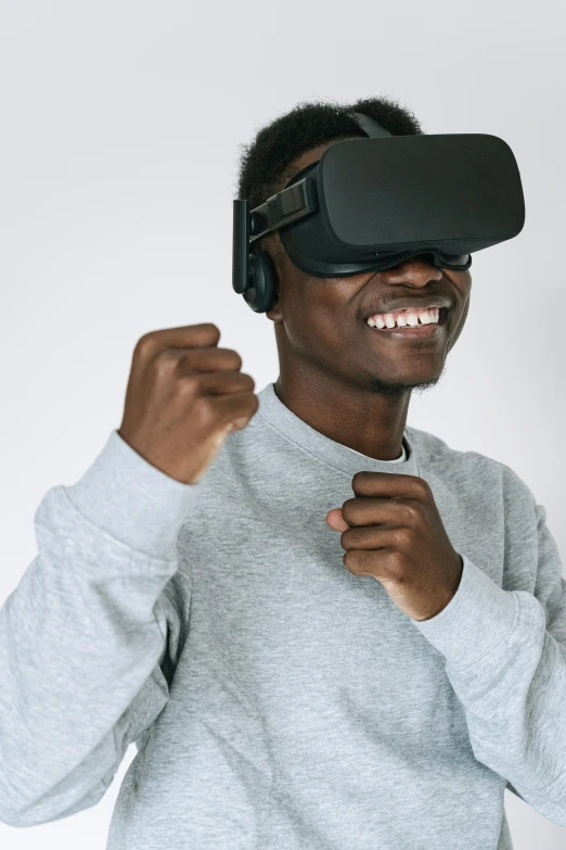 a man wearing a virtual reality headset, trending on unsplash, afrofuturism, brown skin man with a giant grin, 2020 video game screenshot, on a gray background, oculus rift