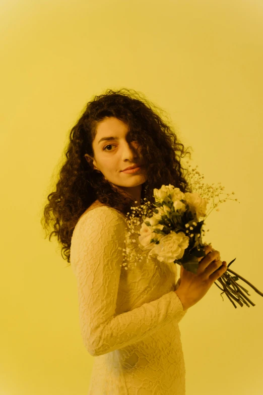 a woman in a white dress holding a bunch of flowers, an album cover, inspired by Elsa Bleda, pexels contest winner, young middle eastern woman, yellow clothes, portrait n - 9, lorde