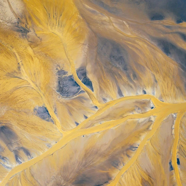 an aerial view of a river running through a valley, inspired by national geographic, unsplash contest winner, land art, yellow ochre, mongolia, abstract detail, tumbleweeds