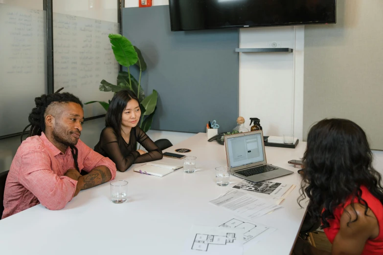 a group of people sitting around a white table, profile image