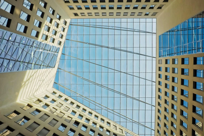 a very tall building with a lot of windows, an album cover, inspired by Hans Mertens, unsplash, skylight open ceiling, wim crouwel, square lines, a wide open courtyard in an epic