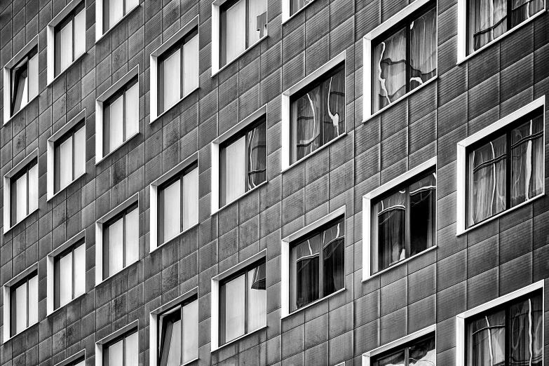 a black and white photo of a tall building, a black and white photo, by Sven Erixson, broken windows, shot on 1 5 0 mm, vibrant patterns, hdr detail