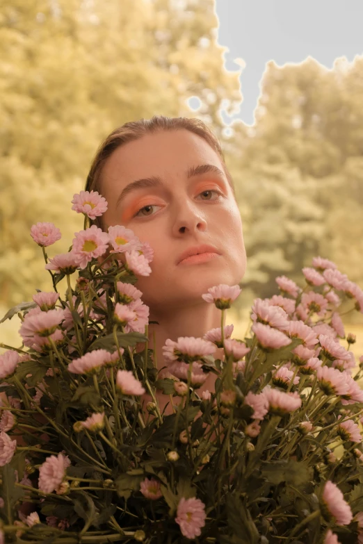 a woman holding a bunch of flowers in front of her face, an album cover, inspired by Elsa Bleda, pexels contest winner, natalia dyer, portrait sophie mudd, soft light 4 k in pink, elle fanning)