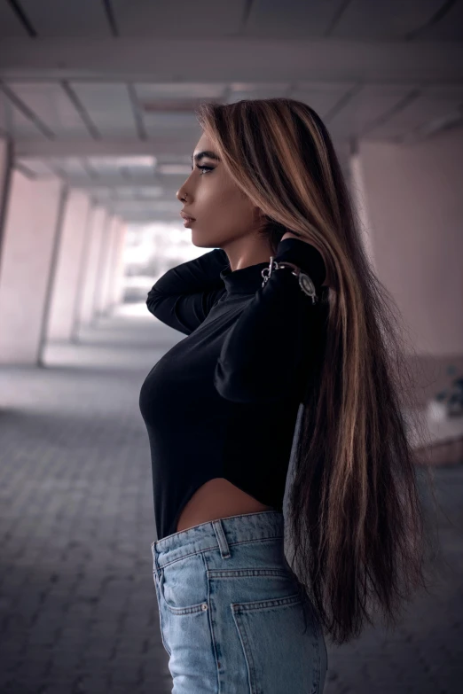 a woman with long hair standing in an empty building, an album cover, inspired by Elsa Bleda, trending on pexels, renaissance, black turtle neck shirt, street pic, crop top, anna nikonova aka newmilky