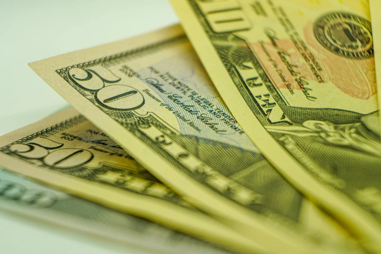 a pile of money sitting on top of a table