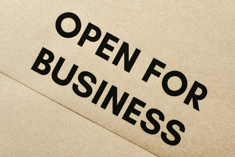 an open for business sign on a piece of cardboard, private press, rich evans, square, thumbnail, concern