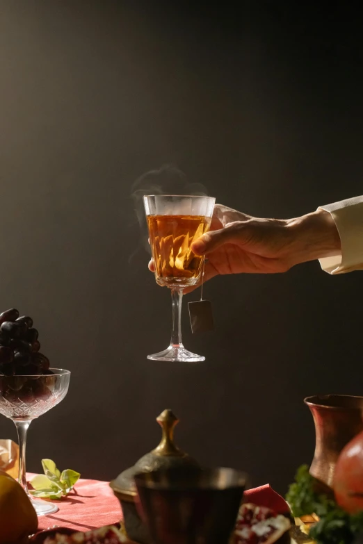 a close up of a person holding a glass of wine, a still life, inspired by Georges de La Tour, liquid translucent amber, very smoky paris bar, image apothecary, flying shot