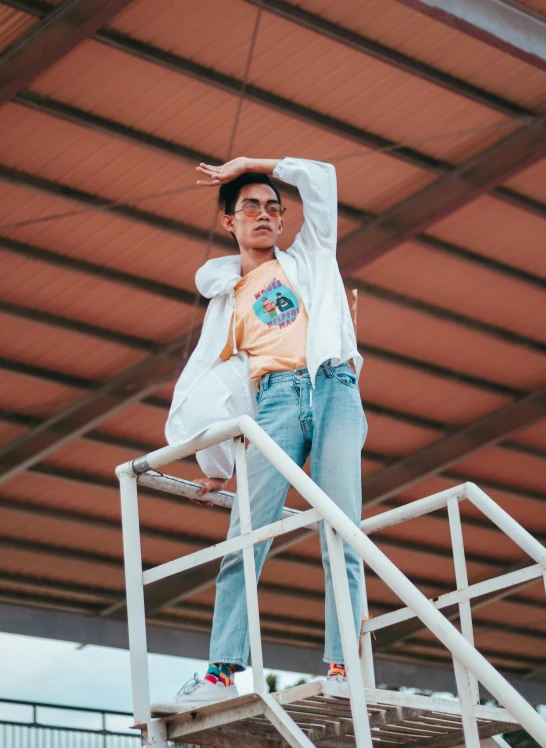 a man standing on top of a set of stairs, by Olivia Peguero, happening, festival vibes, wearing a light shirt, cindy avelino, keng lye