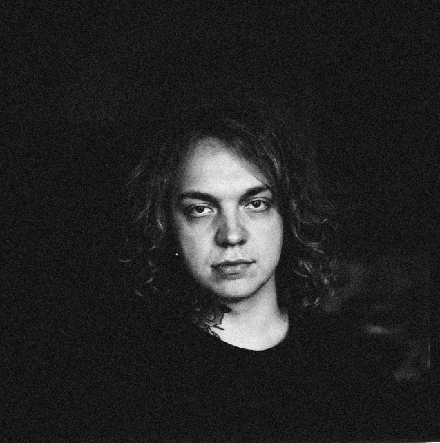 a black and white photo of a woman with long hair, a black and white photo, inspired by Lasar Segall, frank dillane as puck, washed out color, official photo, russell dauterman