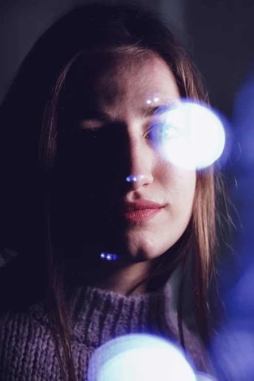 a close up of a person holding a light, looking into the camera, gravitational lenses, woman's face looking off camera, lights on