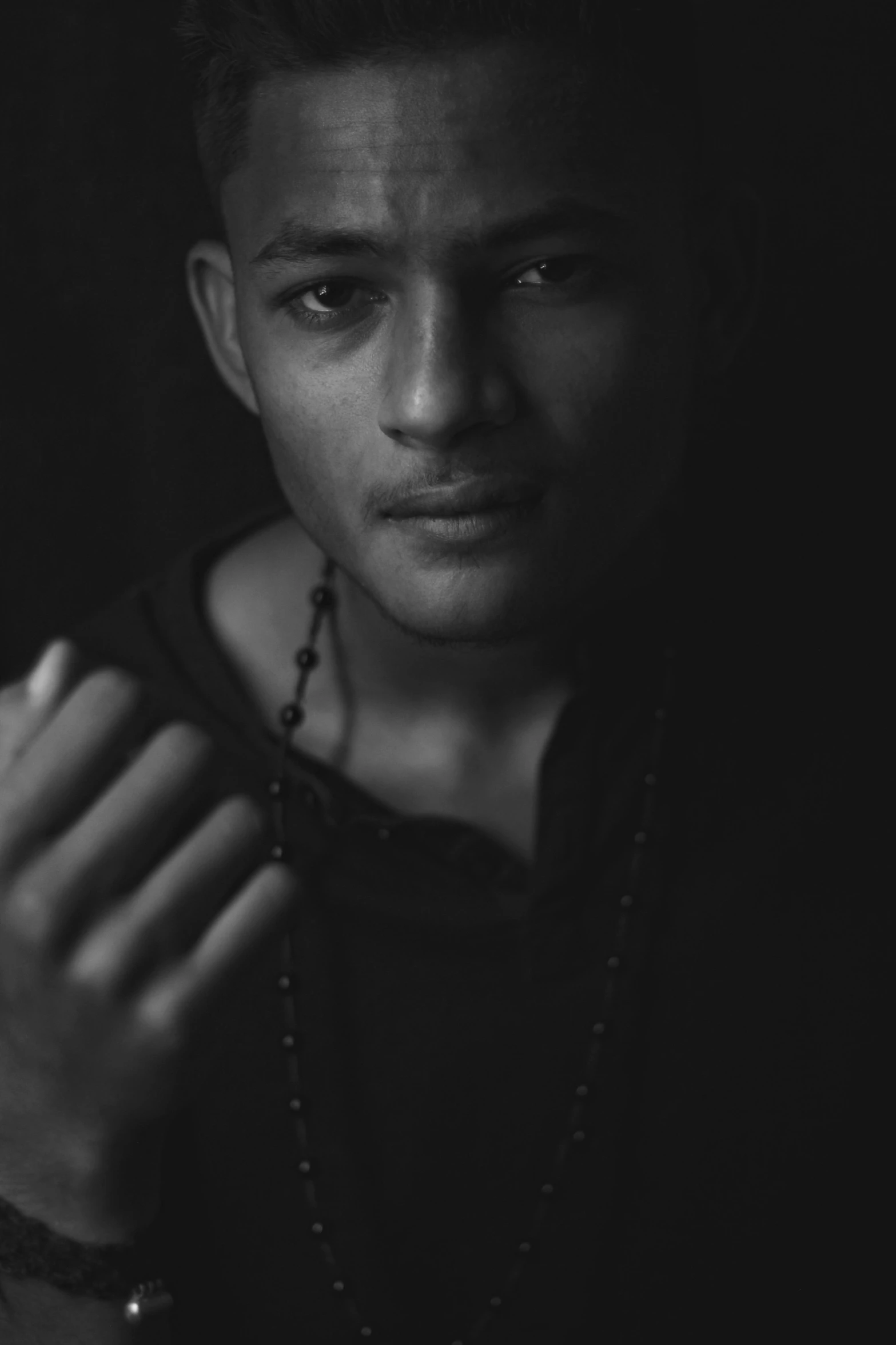 a black and white photo of a young man, a black and white photo, unsplash, renaissance, neymar, indigo, dark and realistic, amr elshamy