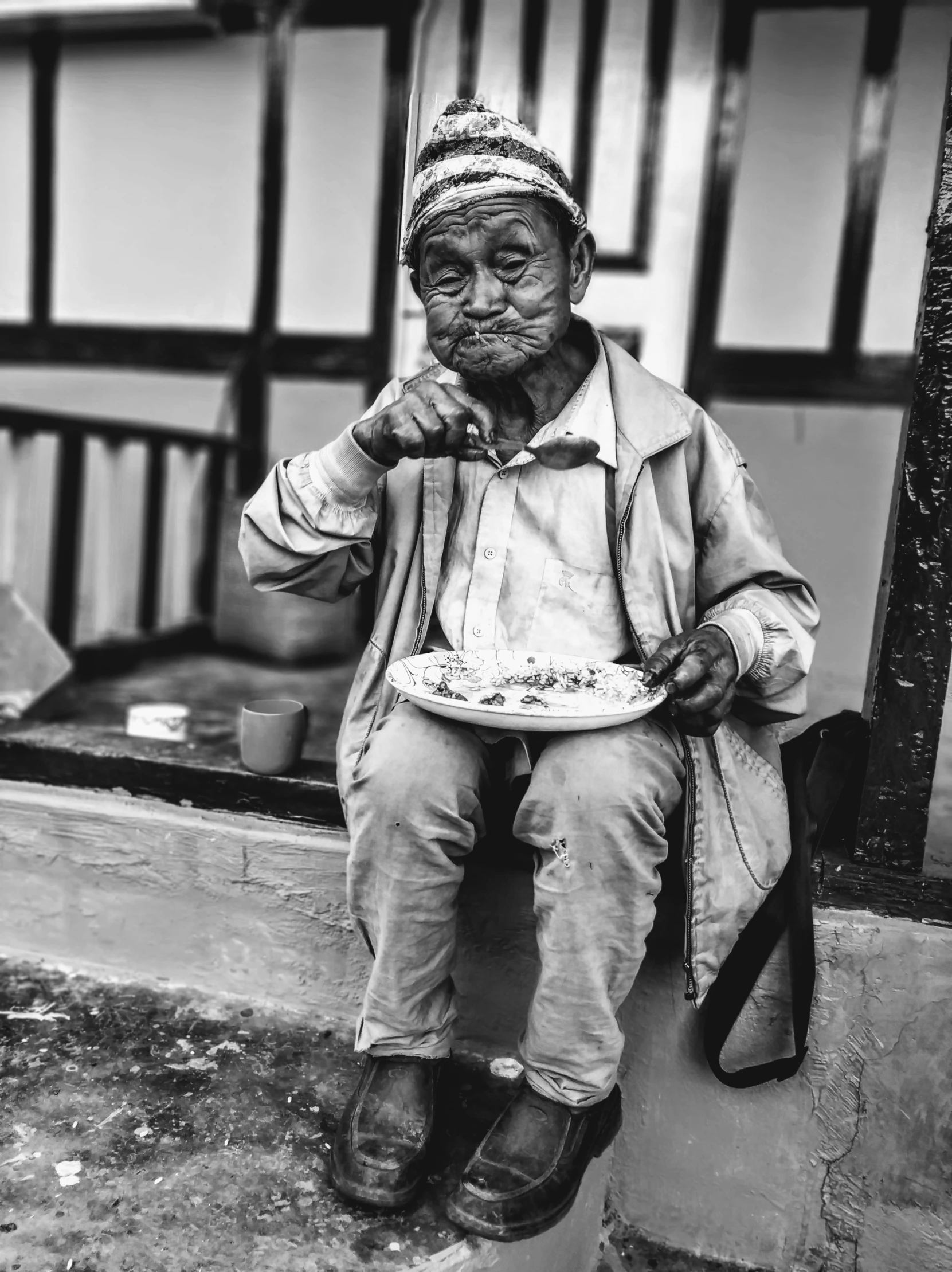 a black and white photo of a man with a plate of food, by Joze Ciuha, sumatraism, cinematic. by leng jun, bo xun ling, ivan bolivian, enhanced photo