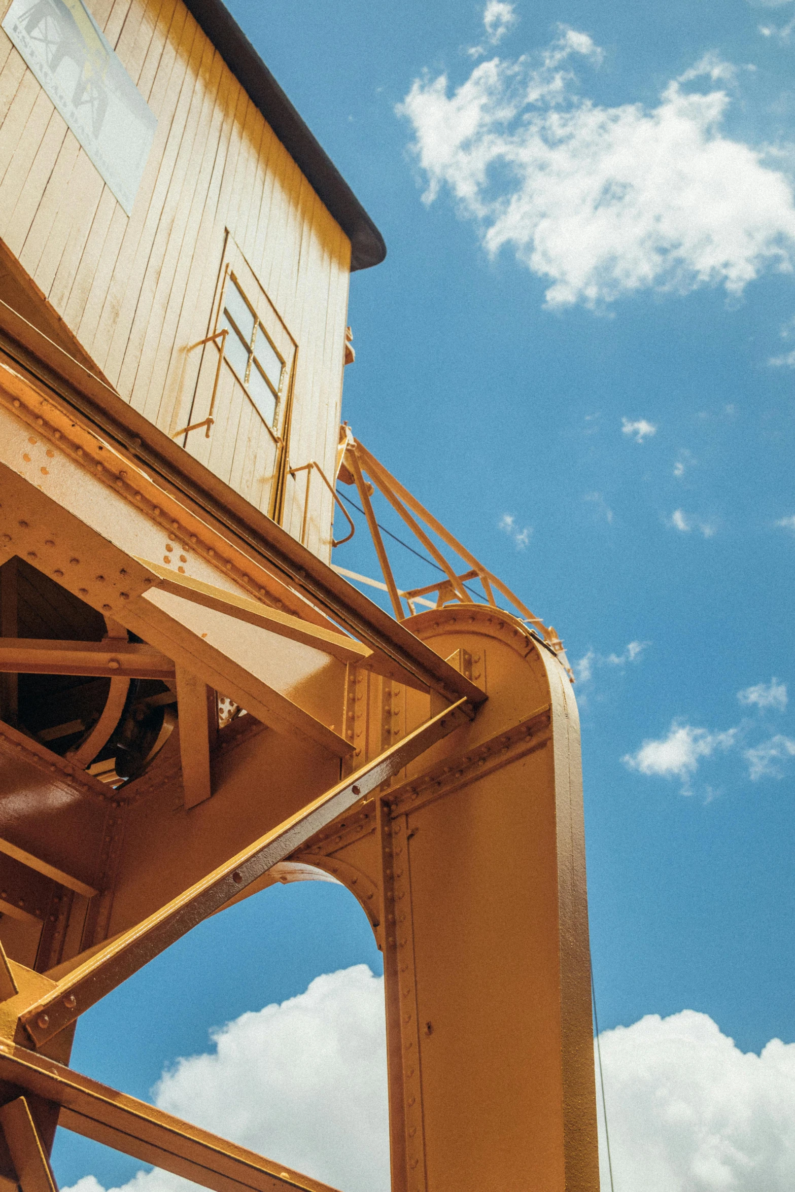 a man riding a skateboard on top of a metal structure, heavy machinery, sea cloud, up-close, ochre