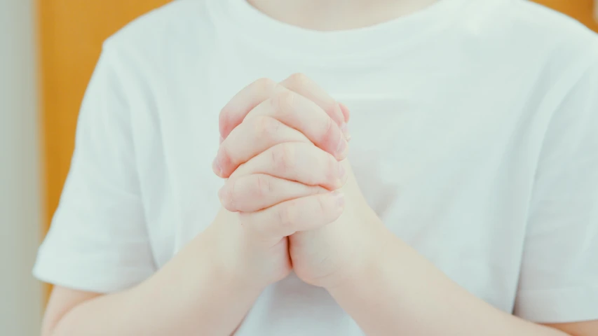 a close up of a person holding their hands together, by Francis Helps, little boy wearing nun outfit, profile image, recovering from pain, instagram post
