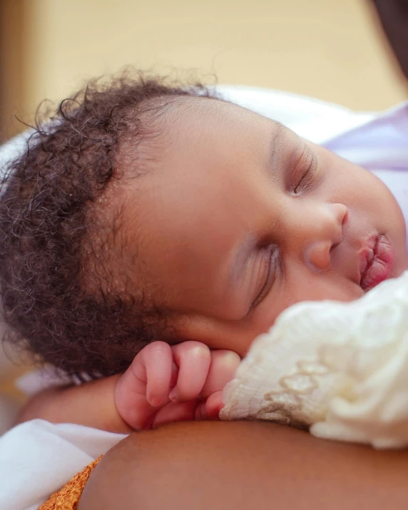 a close up of a person holding a baby, brown skinned, asleep, no cropping, instagram post