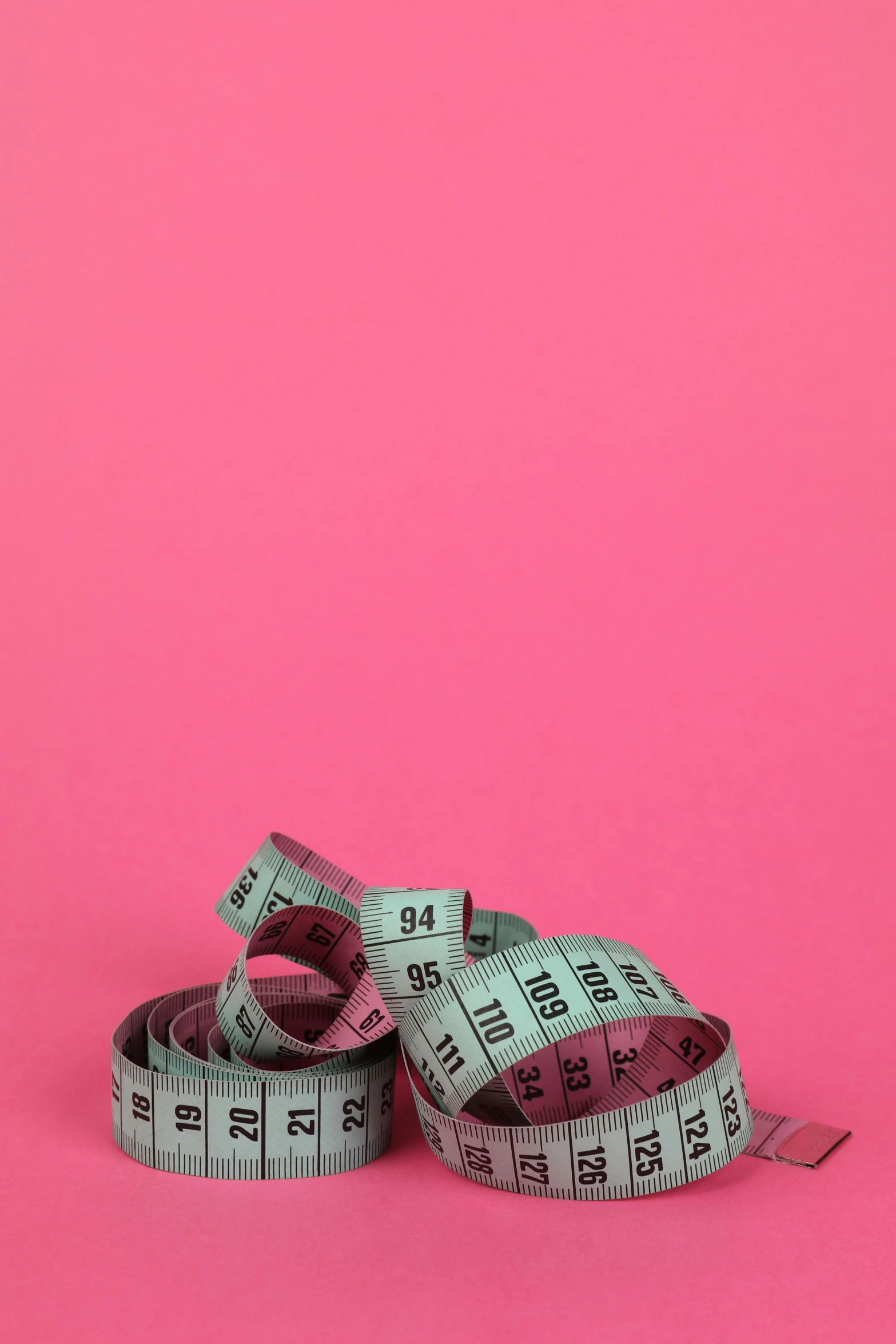 a pair of measuring tape on a pink background, pexels, happening, half - body composition, elizabeth saltzman, instagram story, big ribbon