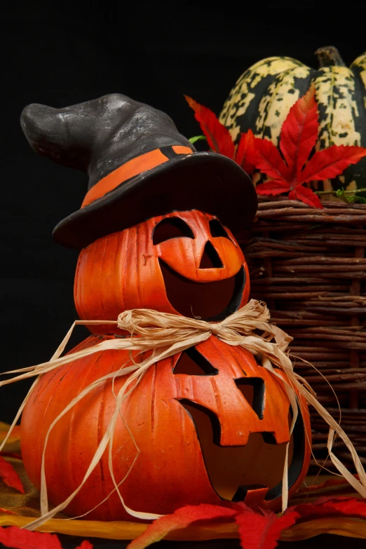 a couple of pumpkins sitting on top of a table, wearing a witch hat, profile image