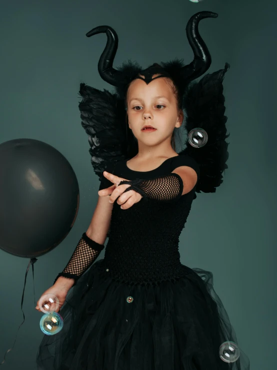 a little girl dressed up as a maleficent, pexels contest winner, greta thunberg, young harpy-girl, black, low quality photo