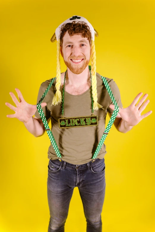 a man standing in front of a yellow background, inspired by Bernd Fasching, long braided green hair, suspenders, beer, asmongold