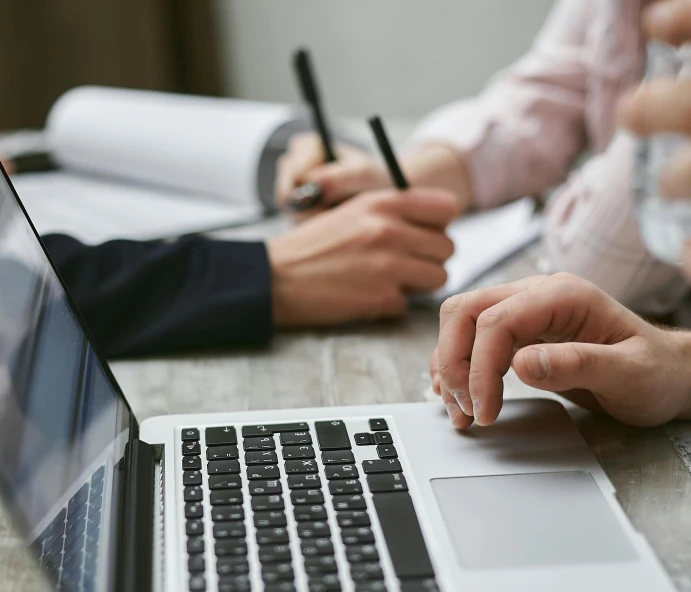 a group of people sitting at a table with laptops, trending on pexels, royal commission, holding pencil, background image, te pae