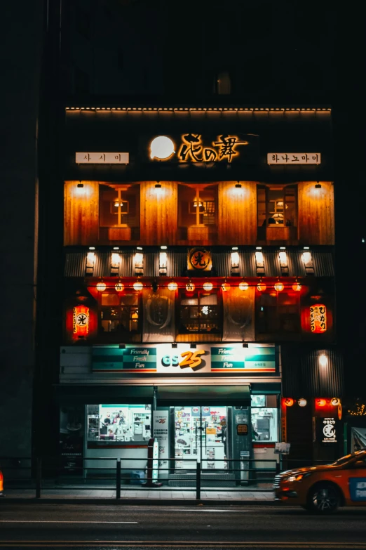 a car parked in front of a building at night, pexels contest winner, in front of ramen shop, high detailed store, chinese building, facing front