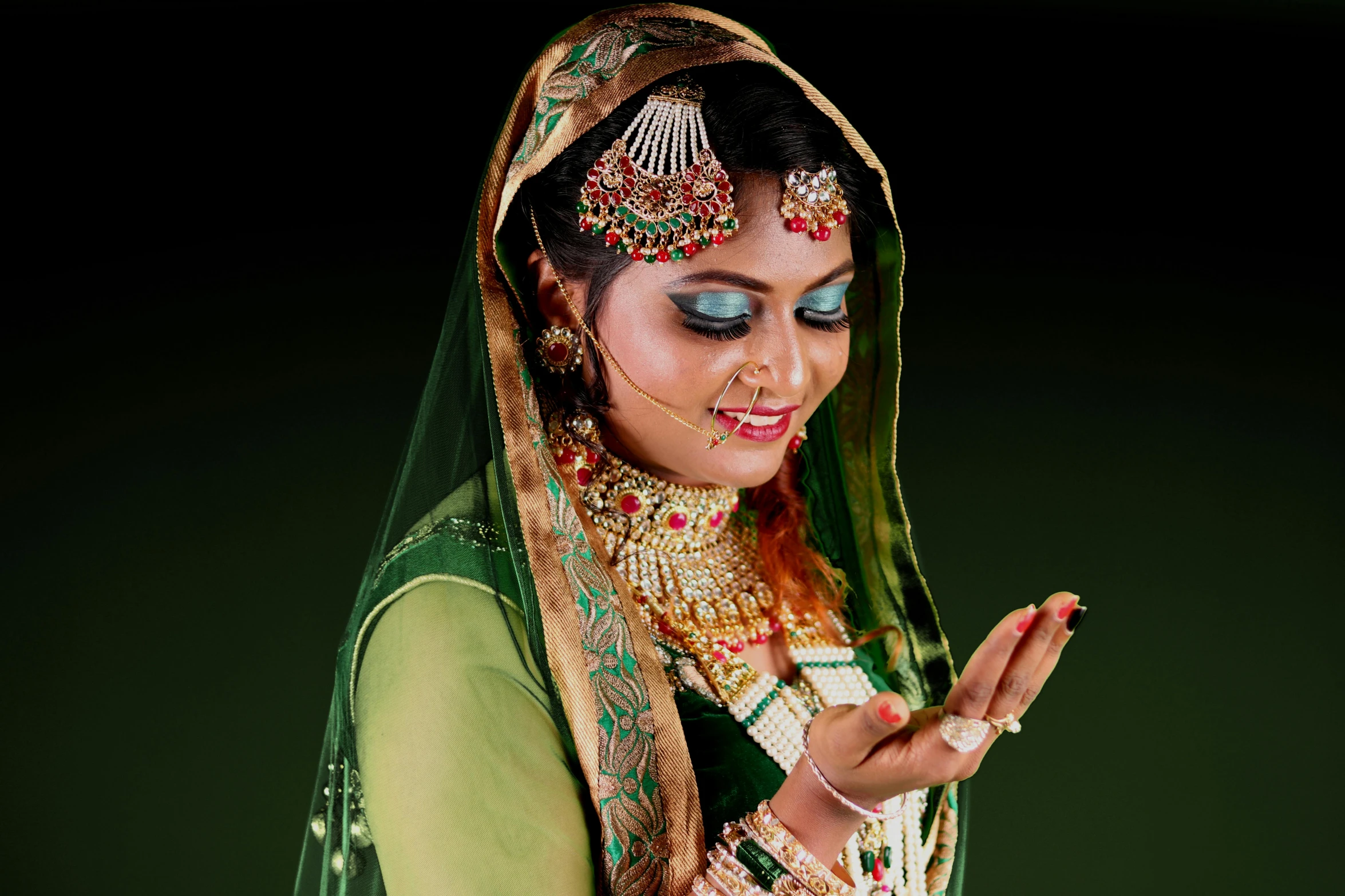 a woman dressed in a green and gold outfit, by Sudip Roy, pixabay, hurufiyya, traditional makeup, square, led, professionally color graded