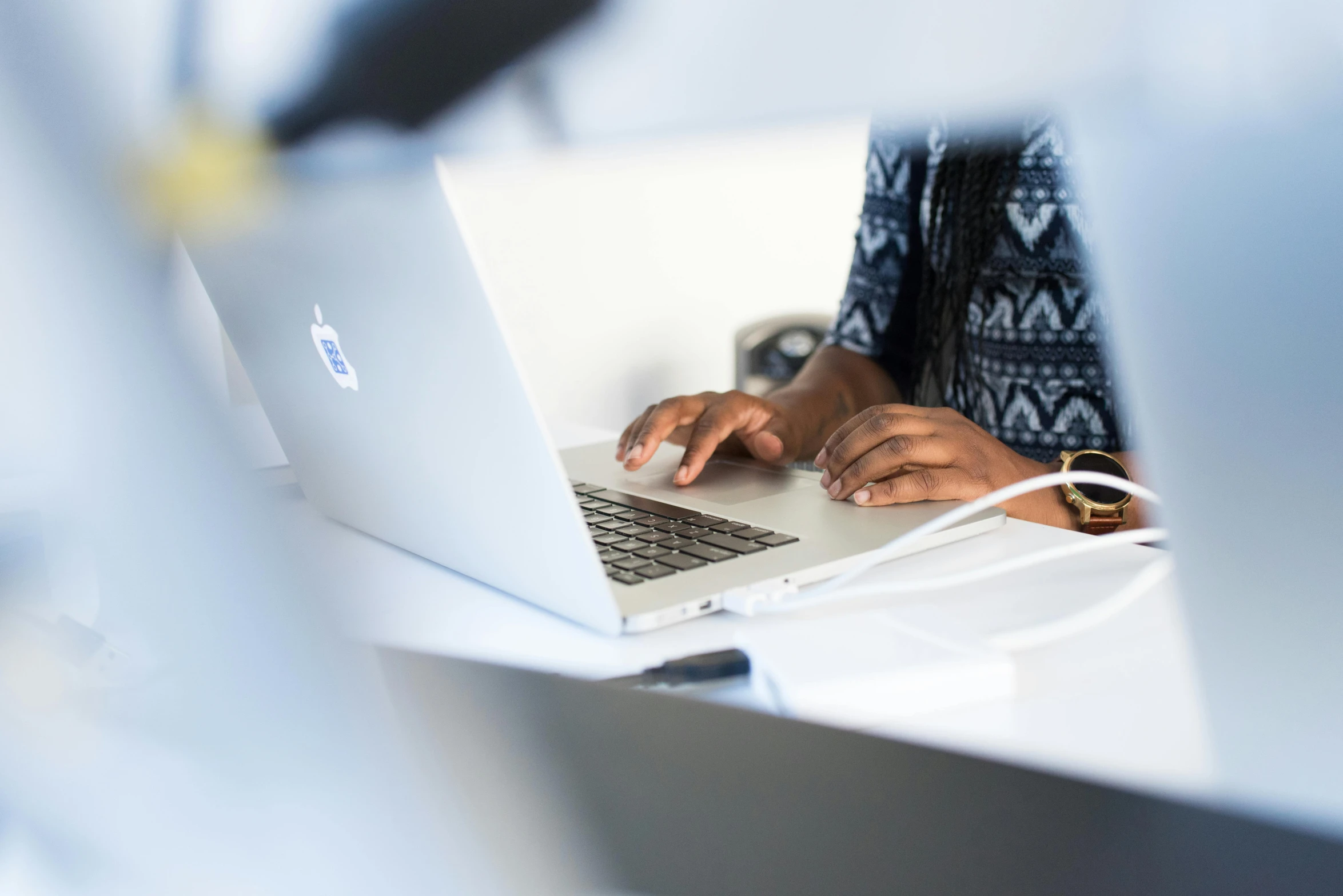 a woman sitting at a desk using a laptop computer, by Carey Morris, trending on unsplash, bottom angle, afro tech, government archive photograph, creative coding