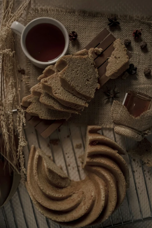 a bunch of cookies sitting on top of a table, a still life, by Adam Marczyński, trending on unsplash, renaissance, brown bread with sliced salo, with a bundt bundt pan face, sepia colors, shot with sony alpha 1 camera