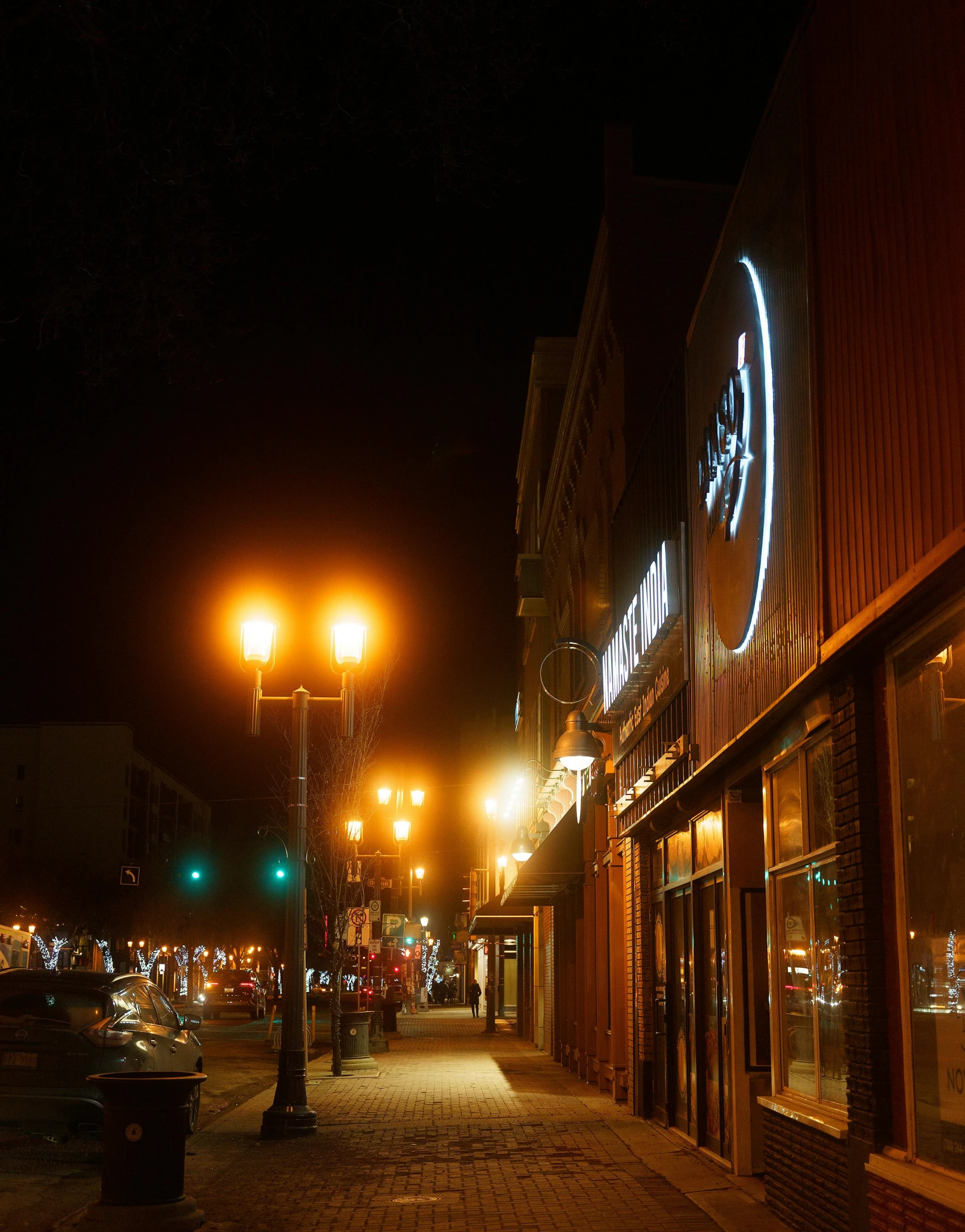 a view of a city street at night, storefront, led lights around the place, dunwall city, fan favorite