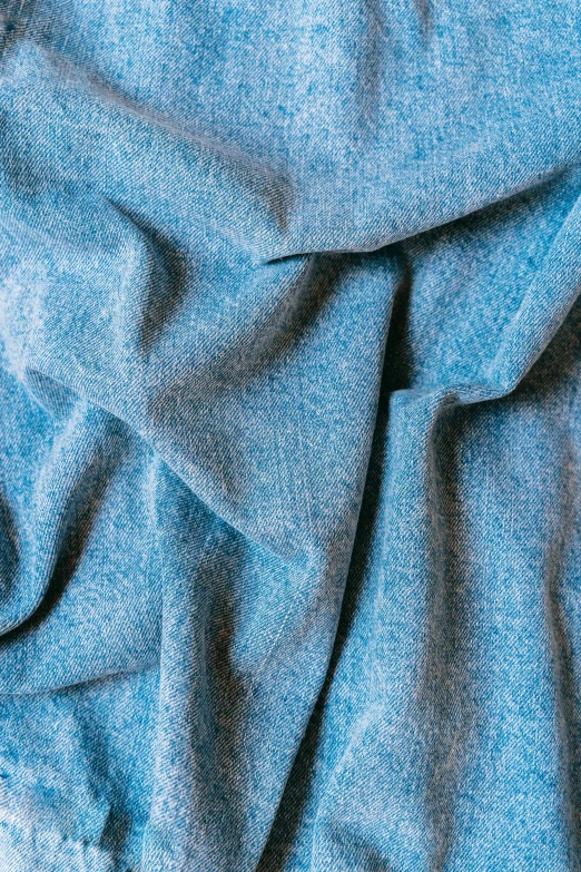 a blue blanket sitting on top of a bed, inspired by George Henry, seamless micro detail, icy, corduroy, slide show