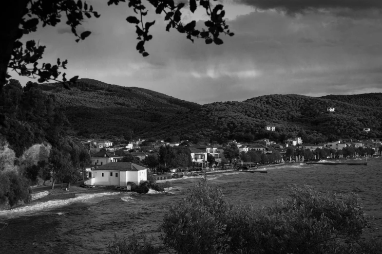 a black and white photo of a small town, by Michalis Oikonomou, flickr, square, island landscape, late summer evening, hideen village in the forest