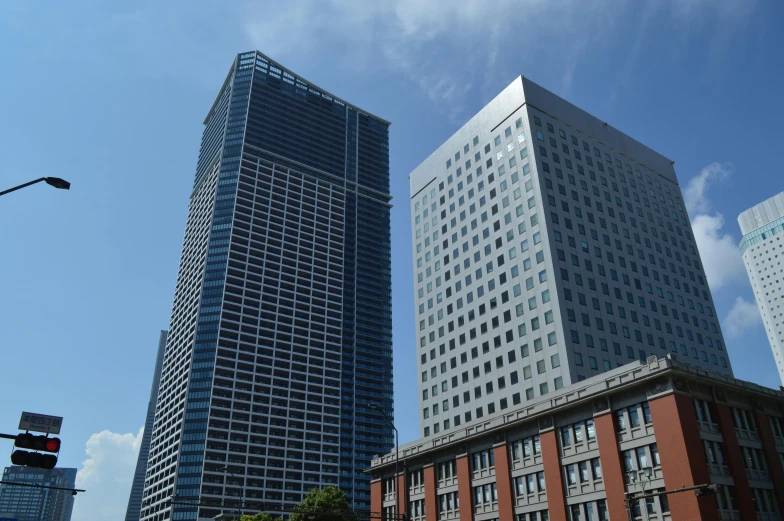 a couple of tall buildings sitting next to each other, a photo, sōsaku hanga, square, high quality image, thumbnail