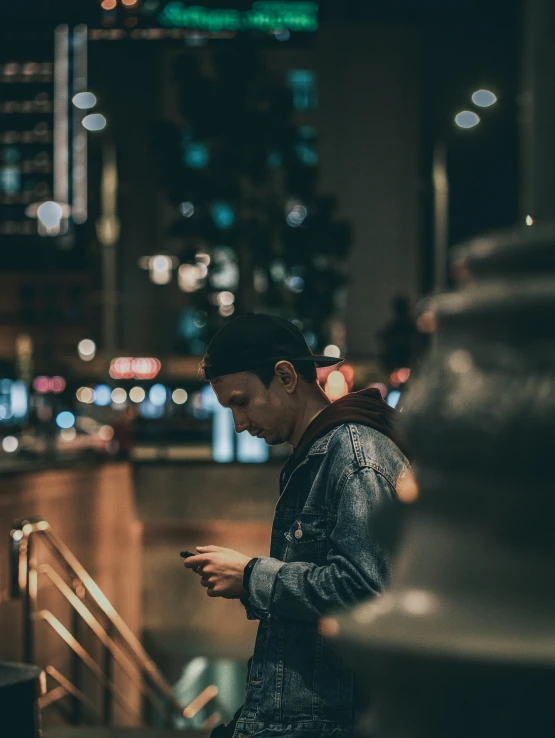 a man looking at his cell phone at night, trending on pexels, a portrait of an android, asian male, modern photo, analog photo