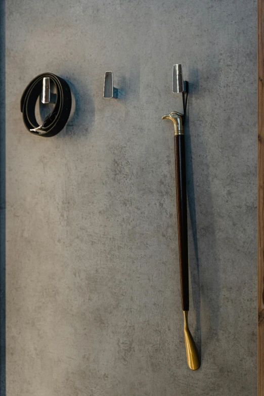 a close up of a metal object on a wall, by Jan Tengnagel, unsplash, conceptual art, with a walking cane, showers, in-game 3d model, bang olufsen