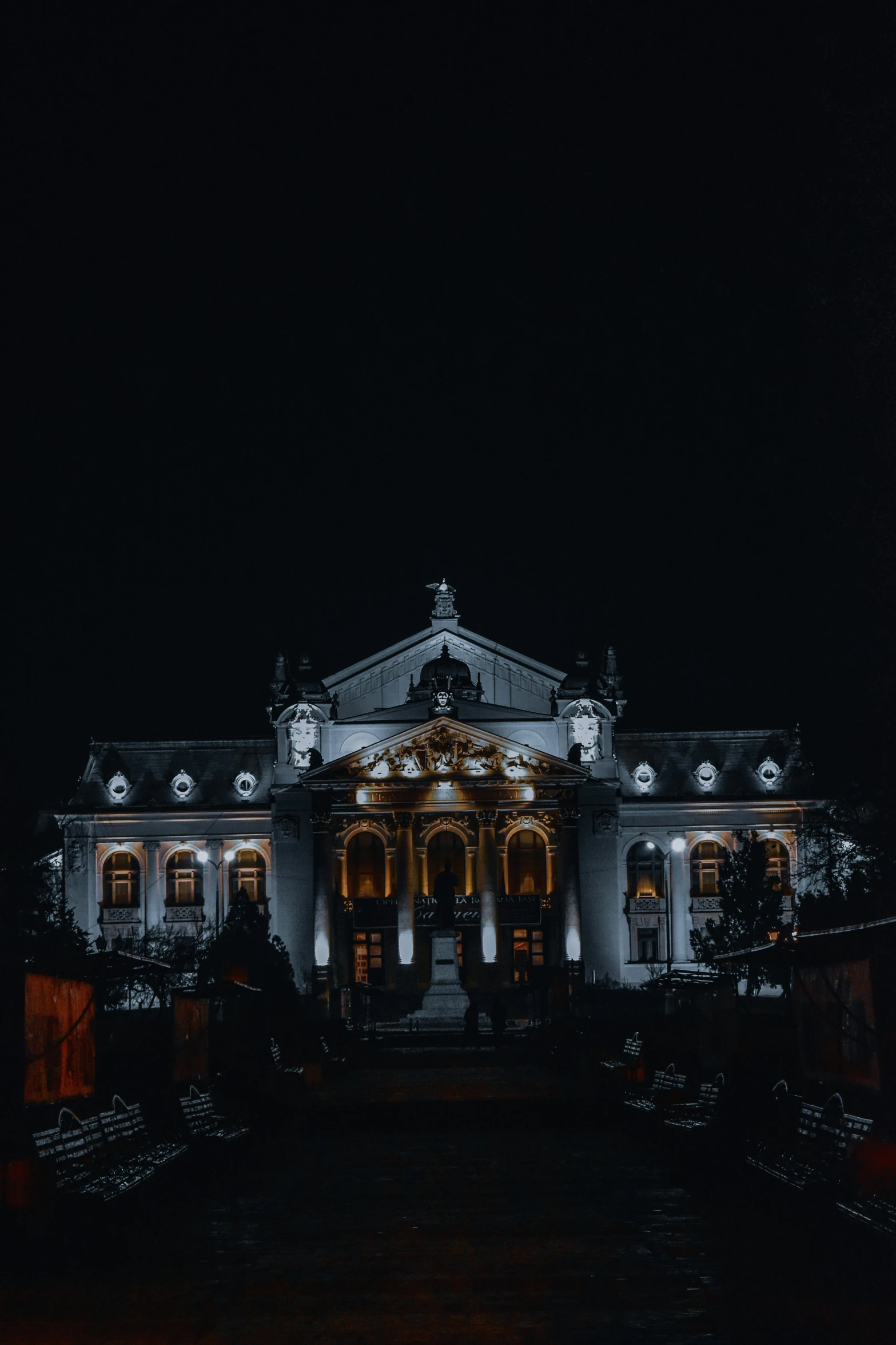 a black and white photo of a building at night, inspired by Mihály Munkácsy, pexels contest winner, baroque, color photo, huge mansion, theater, transylvania