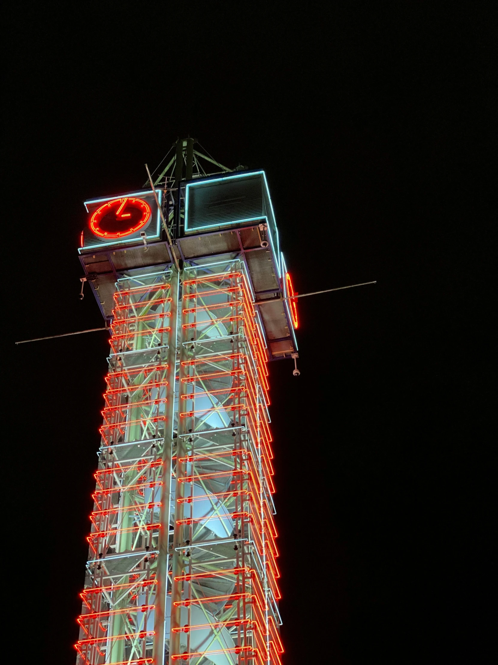a tall tower with a clock on top of it, by Andrei Kolkoutine, unsplash, kinetic art, red and white neon, amusement park, 2 5 6 x 2 5 6 pixels, close up shot from the top