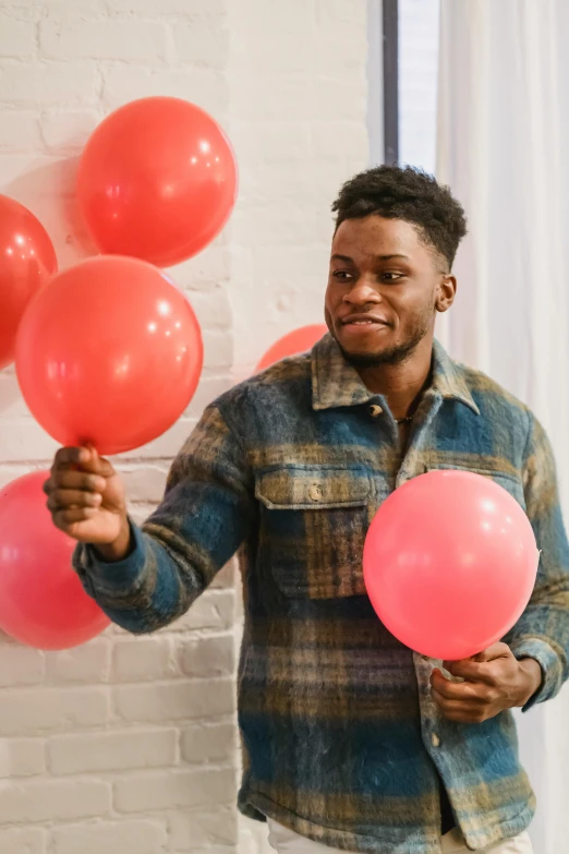 a man holding a bunch of red and pink balloons, jaylen brown, masculine features, grayish, college party
