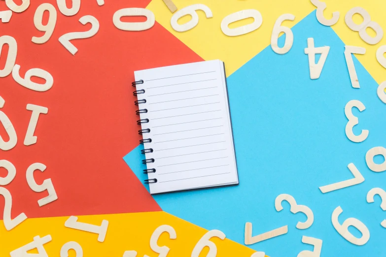 a notepad sitting on top of a pile of numbers, by Julia Pishtar, multicoloured, notebook, thumbnail, red and teal and yellow