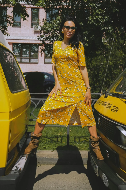 a woman in a yellow dress standing next to a yellow car, by Julia Pishtar, patterned clothing, instagram story, square, full body:: sunny weather::