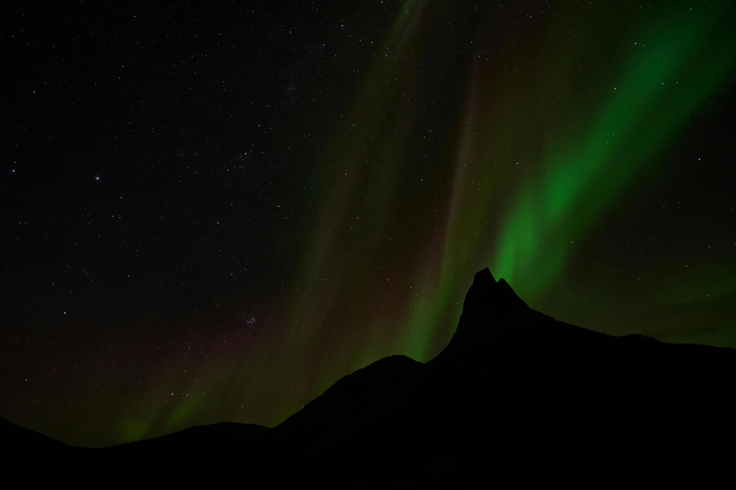 the aurora lights up the night sky over a mountain, by Kristian Zahrtmann, pexels contest winner, hurufiyya, black, 3/4 view from below, mid view, 2022 photograph