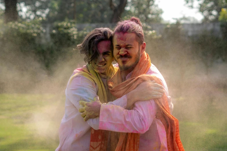 a couple of men standing next to each other, a colorized photo, pexels contest winner, holi festival of rich color, hugging, hindu aesthetic, profile image