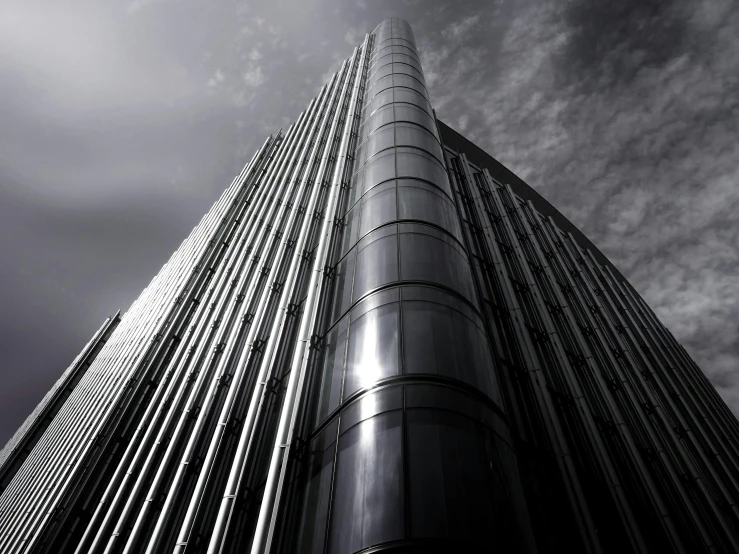 a black and white photo of a tall building, an album cover, inspired by Zaha Hadid, pexels contest winner, shiny metal, anor londo, rounded architecture, glass and metal : : peugot onyx