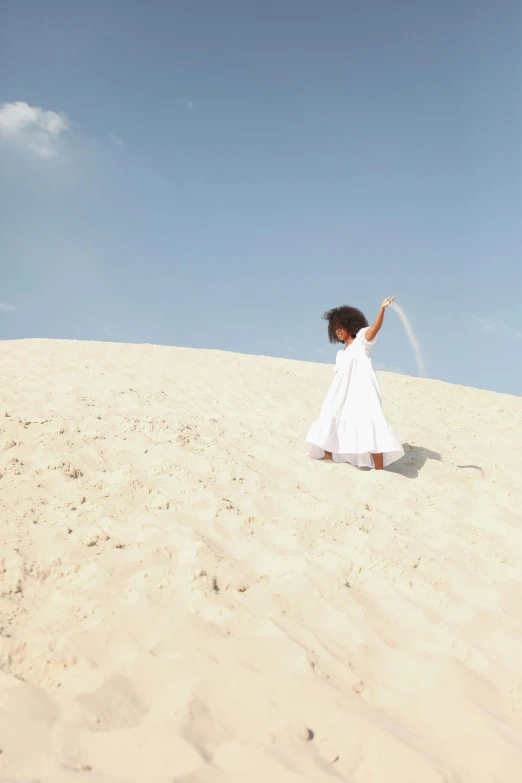 a little girl in a white dress flying a kite, inspired by Scarlett Hooft Graafland, unsplash, sand dune, kano), off - white collection, arabia