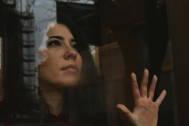 a close up of a person looking out a window, meni chatzipanagiotou, touching, looking confused, fall season