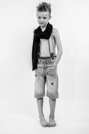 a black and white photo of a young boy, inspired by August Sander, renaissance, denim short pants, wearing torn clothes, die antwoord style wear, bra and shorts streetwear