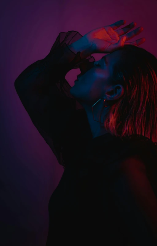 a woman standing in front of a neon light, an album cover, inspired by Elsa Bleda, trending on pexels, profile pose, wet dripping hair, sydney sweeney, dark. studio lighting