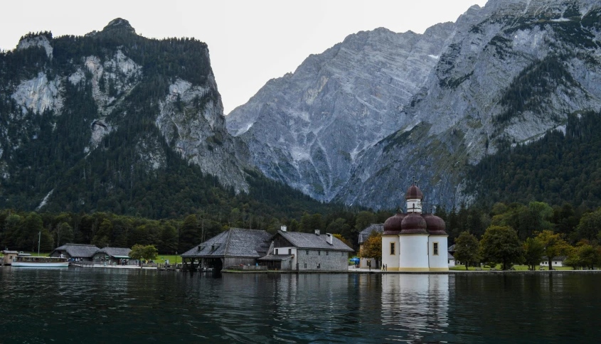 a church in the middle of a lake with mountains in the background, pexels contest winner, modernism, biedermeier, white marble buildings, camp, dim