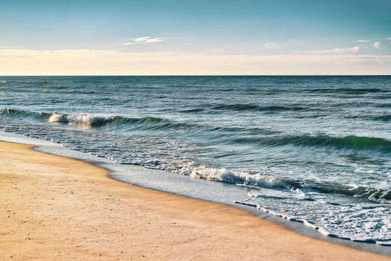 a man riding a surfboard on top of a sandy beach, body of water, omaha beach, the ocean, profile image